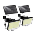 Two wireless solar motion-sensor floodlights mounted outdoors on a wall